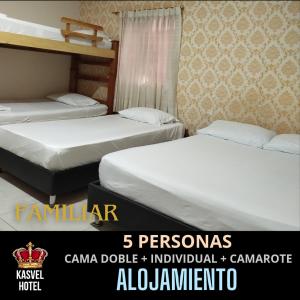 two beds in a hotel room with at Hotel Kasvel in Valledupar