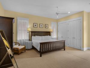 a bedroom with a large bed and a chair at Soleil Levant by Newman-Dailey in Destin