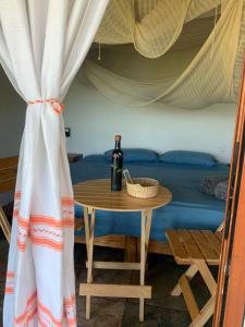 einen Tisch mit einer Flasche Wein auf dem Bett in der Unterkunft La Aldea Zipolite in Zipolite