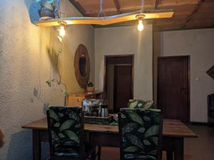 a dining room with a wooden table and chairs at Gaga apartment in Gasanze