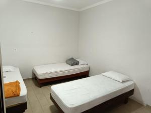 Cama ou camas em um quarto em Hostel Diniz