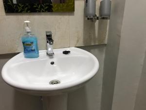 a white sink with a bottle of soap on it at JnB Naivasha town 1Bedroom in Naivasha