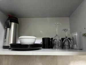 a shelf with plates and other items on it at JnB Naivasha town 1Bedroom in Naivasha +9 photos