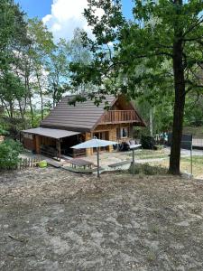 a small house with a roof and a tree at Dream Forest Cabin in Warsaw