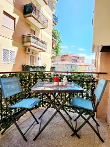 un tavolo e 2 sedie sul balcone di Appartamento comodo e accogliente a Ciampino a Ciampino