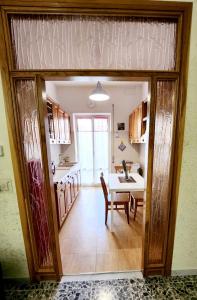 a kitchen with a table and a dining room at Appartamento comodo e accogliente a Ciampino in Ciampino