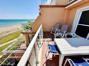 a balcony with a table and chairs and the beach at Mirador al Mar 12 in Denia