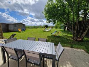 a picnic table and chairs in a yard at Gite entre Loire, châteaux et Sologne in Saint-Claude-de-Diray