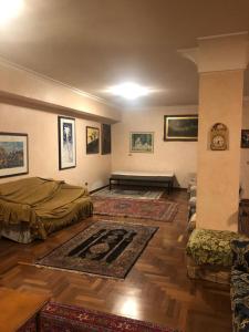 a living room with two beds and a rug at Ameno house in Casale SantʼAntonio