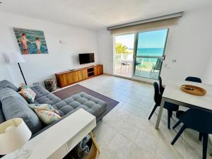 a living room with a couch and a table at Mirador al Mar 12 in Denia