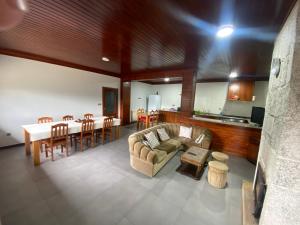 a living room with a couch and a table at Casa do Paradela in São Pedro