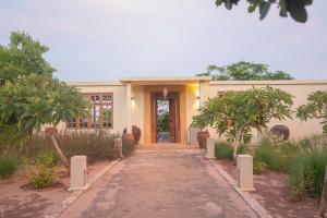 a house with a pathway leading to the front door at Kuza The Palm Villas at Vipingo in Kilifi