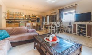 a living room with a couch and a table at Saint George Apartment in Preveza
