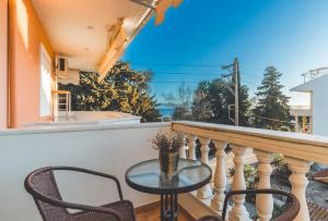 a table and chairs on a balcony with a view at Saint George Apartment in Preveza