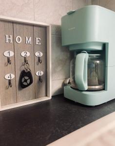 a coffee maker on a counter next to a cabinet at Studio Jardin Fleuris Parking in Nice