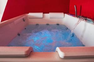 a bath tub with a water fountain in it at Villa Ambra Sicilia in Librizzi +35 photos