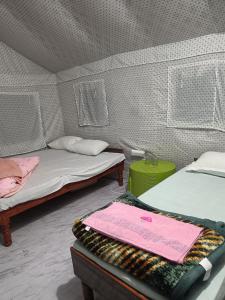 a room with two beds in a tent at Hill dew camps in Uttarkāshi +9 photos