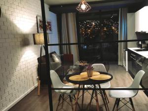 a table and chairs in a room with a window at Modern Apartments in Cape Town