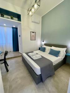 a bedroom with a large bed with a table and a chair at Bausan Avenue in Naples