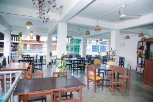 a dining room with wooden tables and chairs at Hotel Shiva's Dream in Sauraha