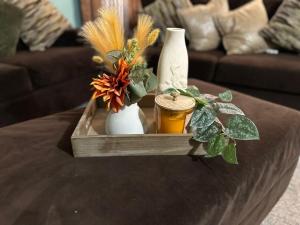 bandeja de madera con jarrones y flores en una mesa en Fan-Ta-Sea, en Johnsons Point