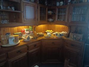 a kitchen with wooden cabinets and fruits on a counter at B&B Ca' dal Sol in Selvanizza