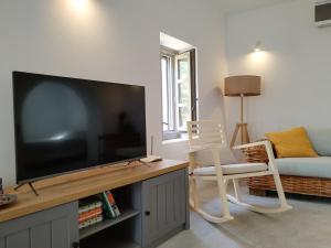 a living room with a large flat screen tv at Oxalis Villas in Perlengiánika