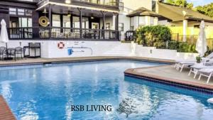 a swimming pool in front of a house at Lakefront Luxe 6BR 4,5BA Holiday Home with Pool & Hot Tub in Rowlett