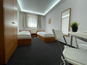 a hotel room with two beds and a mirror at Penzion Šaldorf in Nový Šaldorf +23 photos