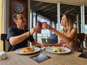 a man and woman sitting at a table with drinks at Simpson Bay Resort Marina & Spa in Simpson Bay