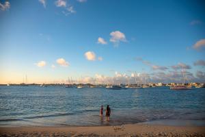 two people standing in the water at the beach at Simpson Bay Resort Marina & Spa in Simpson Bay