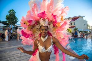 a woman in a pink costume standing by a pool at Simpson Bay Resort Marina & Spa in Simpson Bay