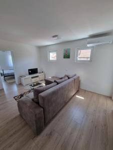 a living room with a couch and a television at Nada-S in Soko Banja