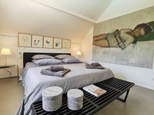 a bedroom with a large bed with pillows on it at Villa Barbot ANGLET Proches Plages in Anglet +12 photos