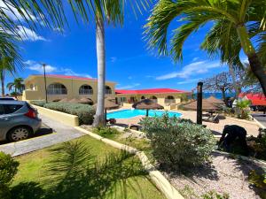 a resort with a swimming pool and palm trees at Simpson Bay Resort Marina & Spa in Simpson Bay
