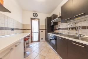 a large kitchen with a sink and a counter at La Cha di Giada in Anzio
