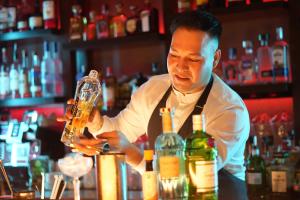 a man preparing a drink at a bar at Simpson Bay Resort Marina & Spa in Simpson Bay