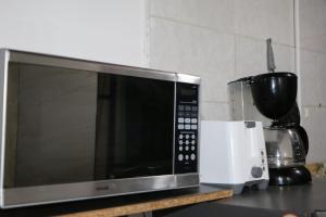 a microwave sitting on top of a kitchen counter at Aparta Suite Torre De Prado 302 in Medellín