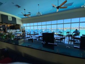 a restaurant with tables and chairs and a view of the water at Simpson Bay Resort Marina & Spa in Simpson Bay