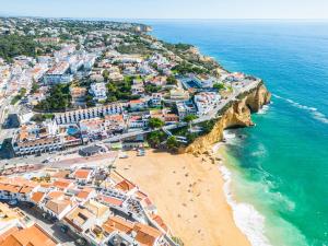 an aerial view of a beach with buildings and the ocean at Apartment Carvoeiro By The Sea 1 by Algarve Vacation in Carvoeiro