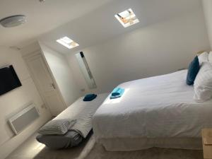 a bedroom with a large white bed and a window at JP Short Stays in Upton upon Severn