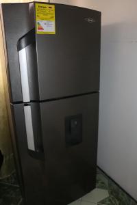 a black refrigerator with a sign on top of it at Aparta Suites Torre de Prado 601 Apartamento para 9 Personas in Medellín