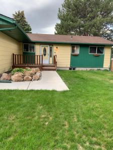 a home with a green and yellow house at Sunny Days! Room for All and Pet Friendly in Pocatello