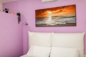 a bedroom with a white bed and a painting on the wall at Luxury Apartments Pantheon Roma in Rome