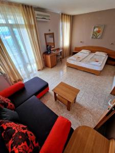 A bed or beds in a room at Family Hotel Selena