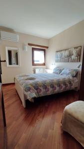 1 dormitorio con 1 cama grande y suelo de madera en Il Bagolaro Casa Vacanze, en Sulmona