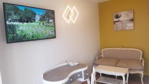 uma sala de espera com uma cadeira e uma televisão em Domaine de Keryargon, Chambres d'hôtes em Belz