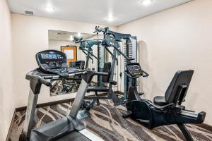 a gym with a treadmill and a elliptical machine at Boarders Inn & Suites by Cobblestone Hotels - Shawano in Shawano