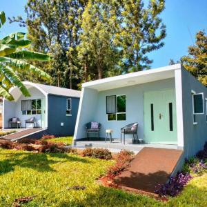 una pequeña casa con una puerta verde en un patio en Kwetu Home - Sagana en Sagana