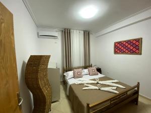 Un dormitorio con una cama con toallas. en Olive Tree Apartment, en Sarandë